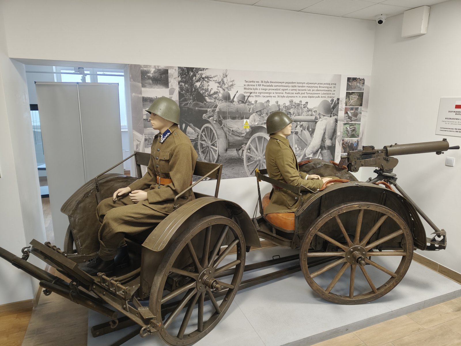 Taczanka z karabinem maszynowym i manekinami żołnierzy na wystawie o bitwach pod Tomaszowem Lubelskim w 1939 roku